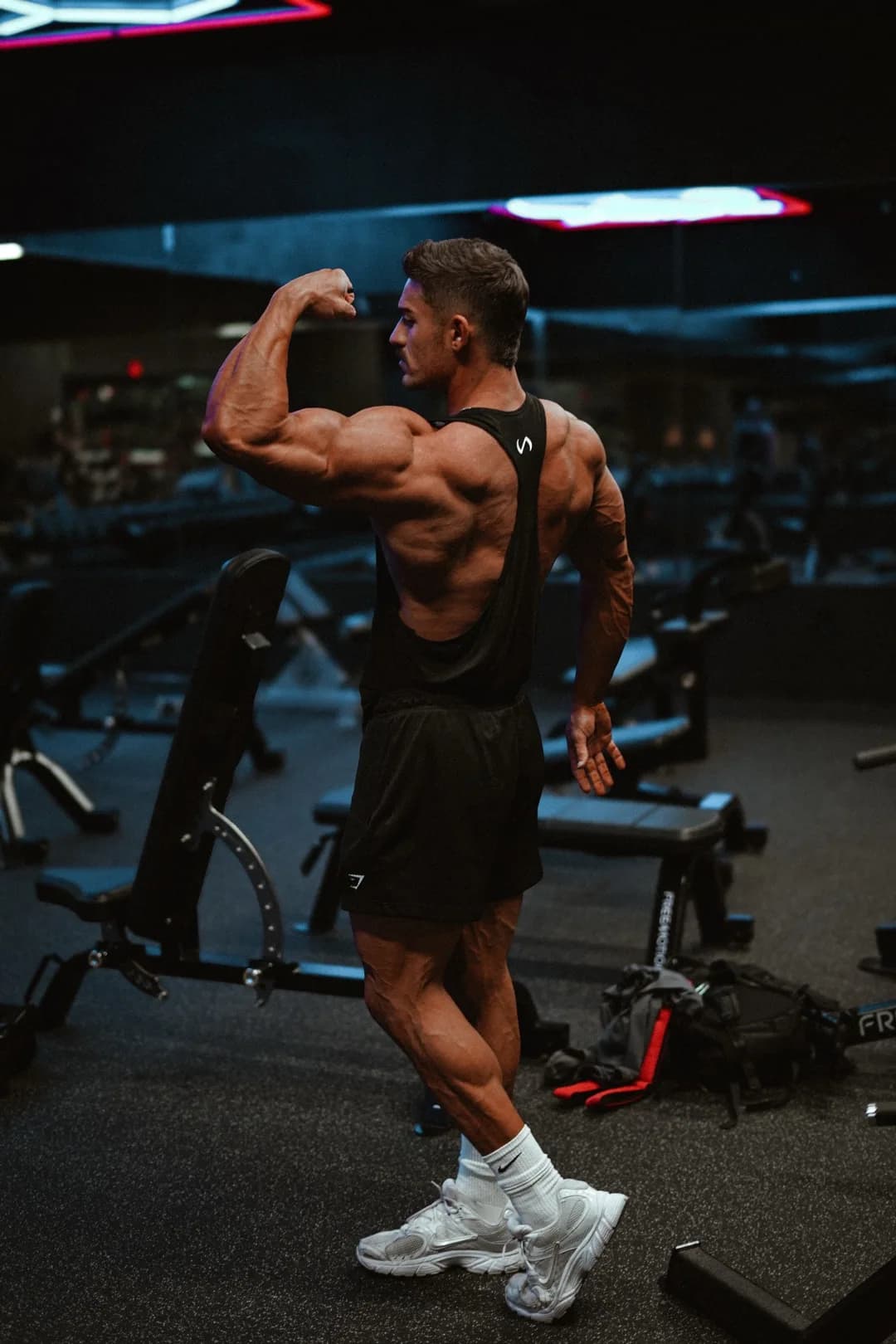 Jared Wagner back double-bicep in the gym
